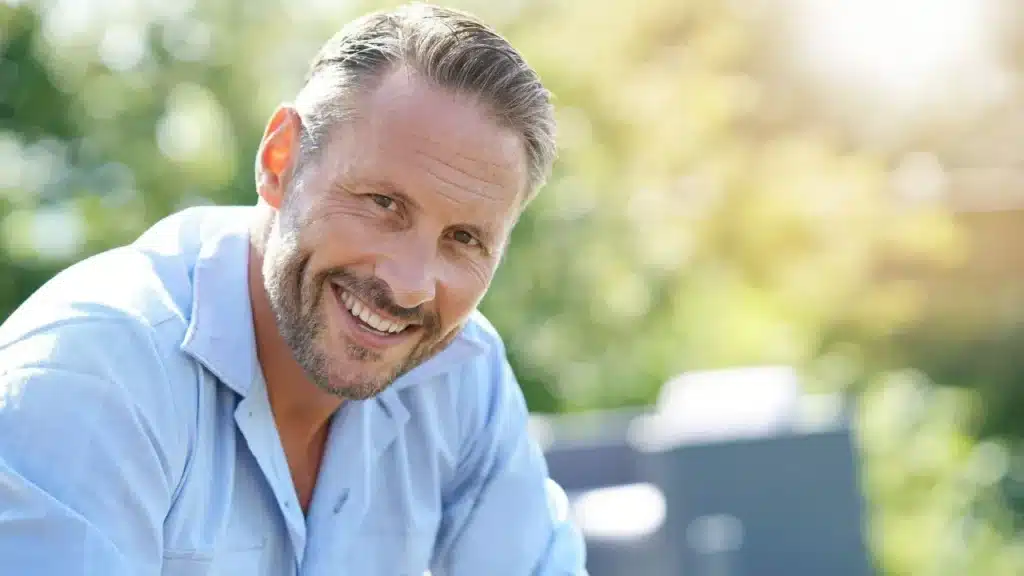 smiling mature man relaxing outside